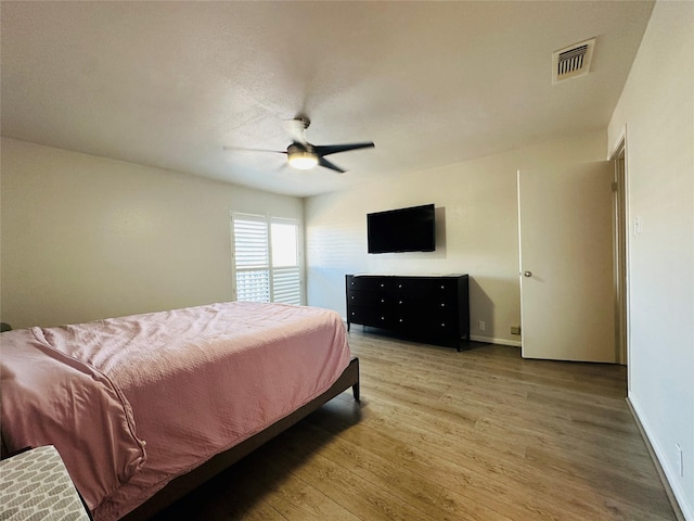 bedroom with hardwood / wood-style floors and ceiling fan