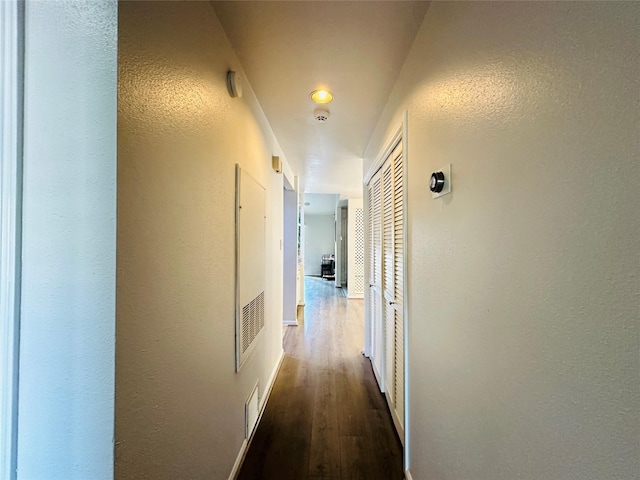 corridor featuring dark hardwood / wood-style flooring