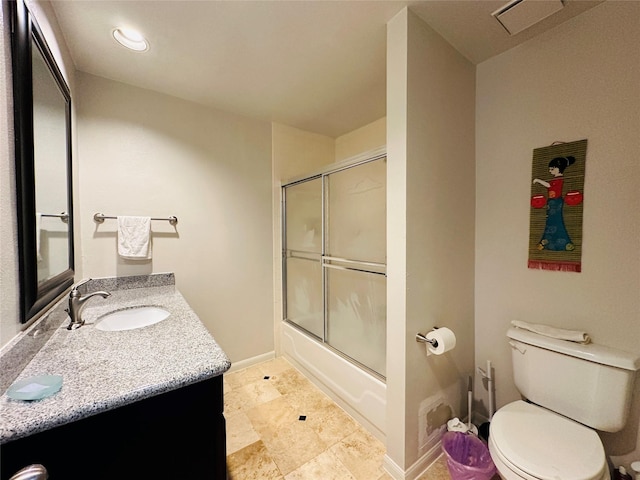 full bathroom featuring vanity, toilet, and shower / bath combination with glass door