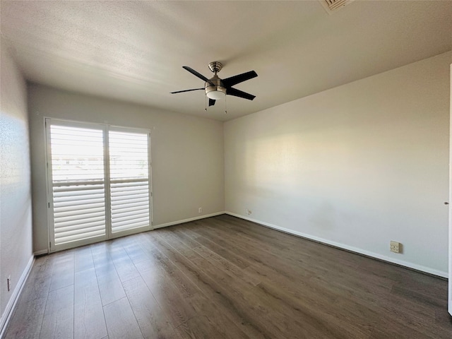 spare room featuring ceiling fan and dark hardwood / wood-style flooring