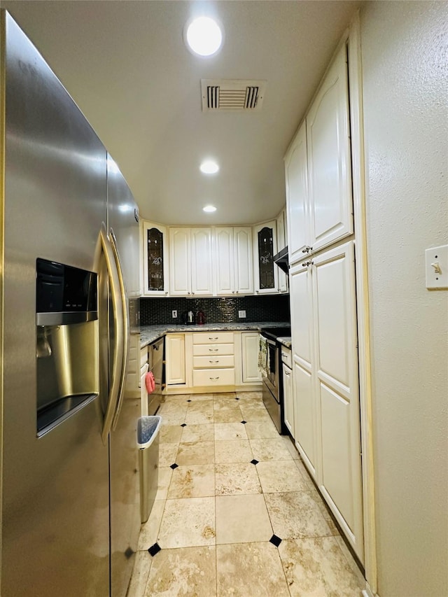 kitchen with decorative backsplash, light tile patterned floors, and appliances with stainless steel finishes