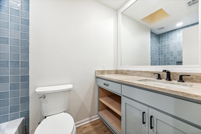 bathroom with vanity, hardwood / wood-style flooring, and toilet