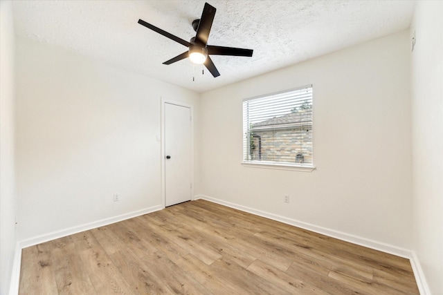 spare room with a textured ceiling, light hardwood / wood-style floors, and ceiling fan