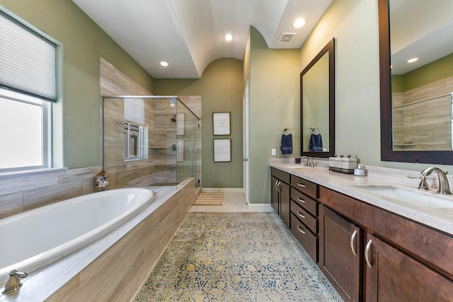 bathroom featuring separate shower and tub and vanity