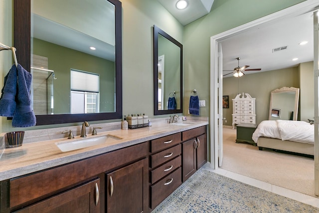 bathroom featuring ceiling fan, an enclosed shower, and vanity