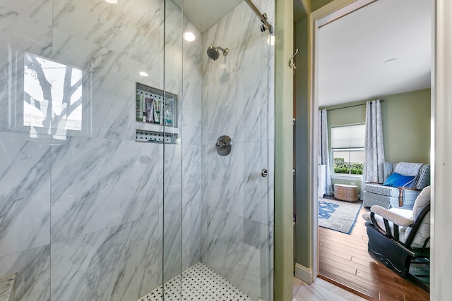 bathroom featuring a shower with door