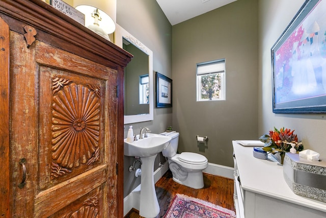 bathroom with hardwood / wood-style floors and toilet