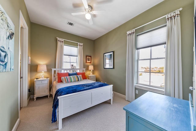 bedroom with ceiling fan and light carpet