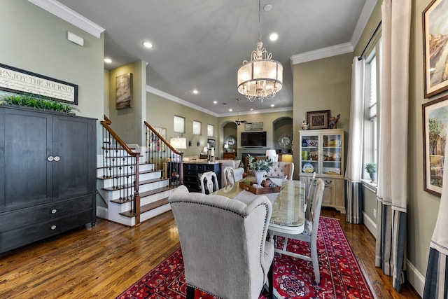 dining room featuring dark hardwood / wood-style flooring, ornamental molding, and a notable chandelier