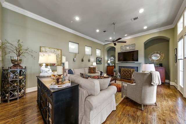 living room with ceiling fan, dark hardwood / wood-style flooring, and crown molding