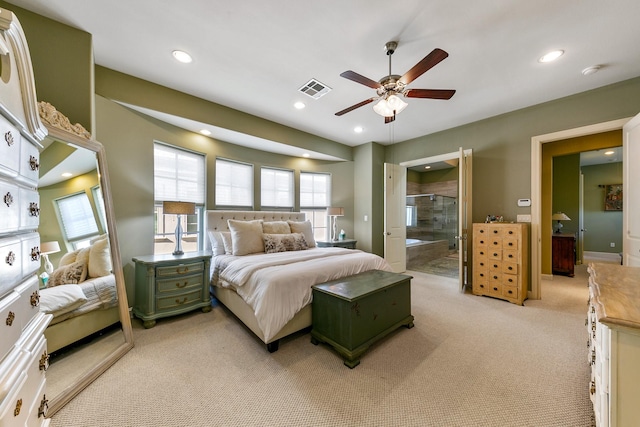 carpeted bedroom featuring connected bathroom and ceiling fan