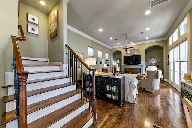 living room featuring ceiling fan, crown molding, and dark hardwood / wood-style floors