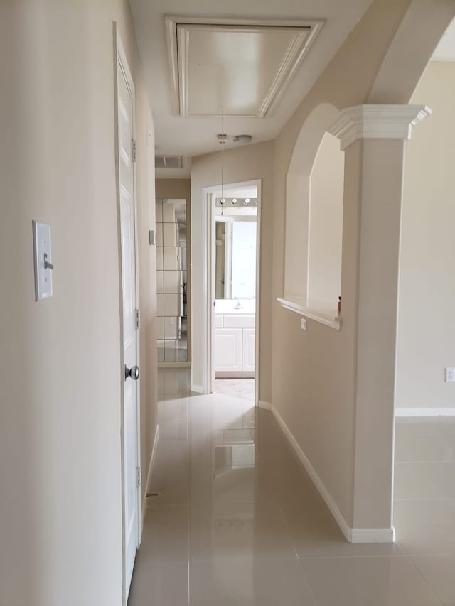 hall featuring light tile patterned floors