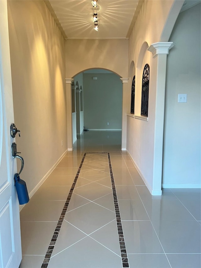 hallway with tile patterned floors and ornate columns