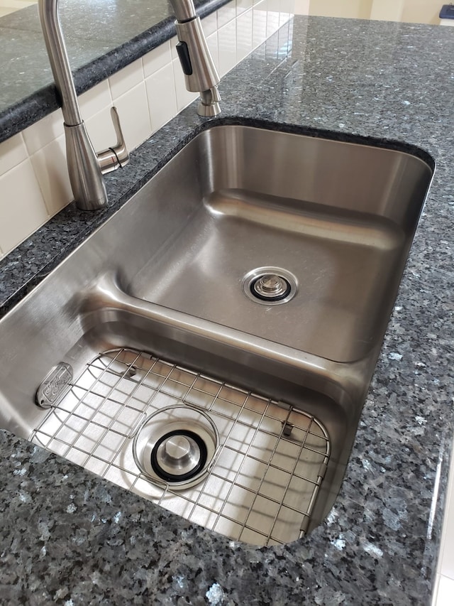 details featuring sink and dark stone counters