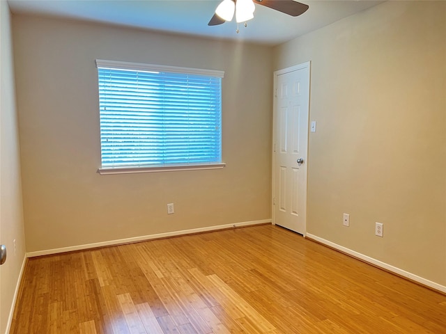 spare room featuring light hardwood / wood-style flooring, a wealth of natural light, and ceiling fan