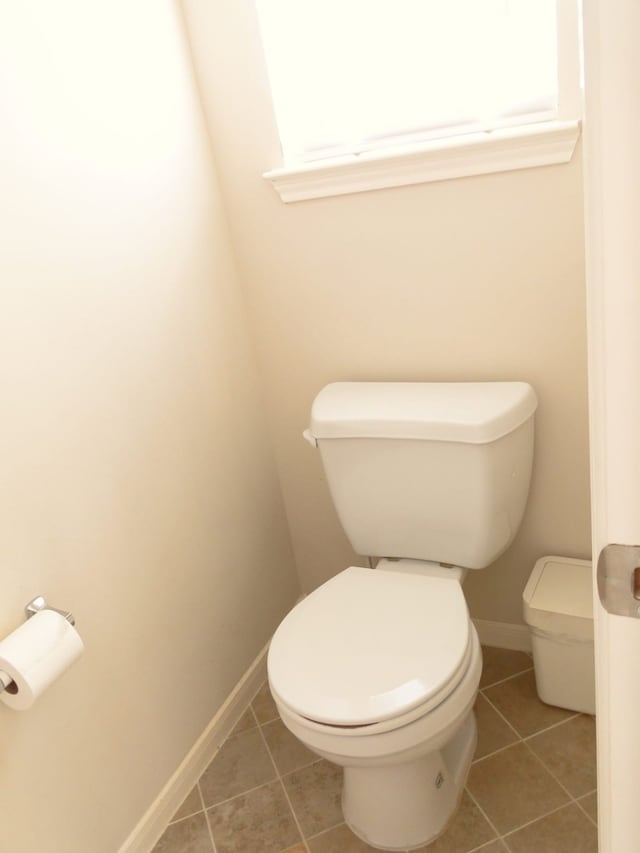 bathroom with tile patterned flooring and toilet