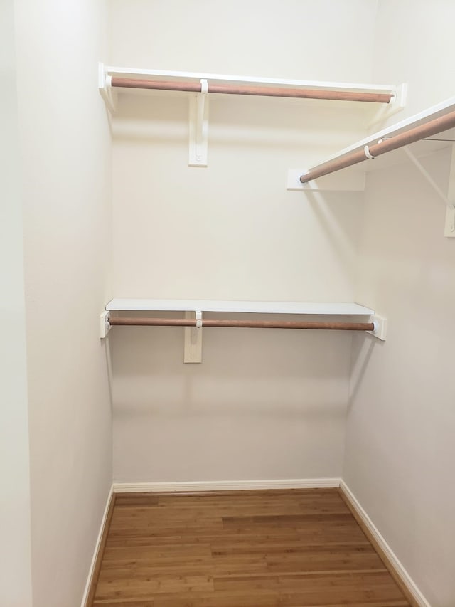 spacious closet featuring hardwood / wood-style floors