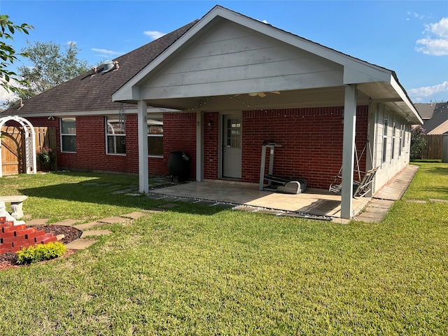 rear view of house with a yard and a patio