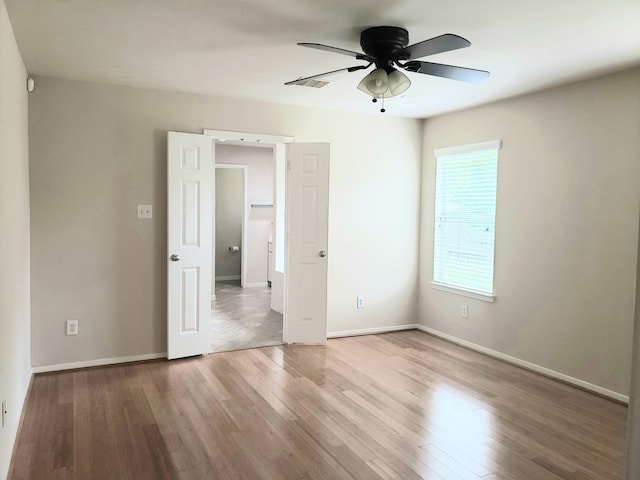 unfurnished bedroom with ceiling fan and light hardwood / wood-style flooring