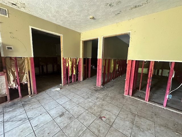 unfurnished room featuring a textured ceiling