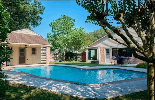 view of swimming pool with a patio area and an outdoor structure