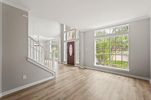 entrance foyer featuring a healthy amount of sunlight and ornamental molding