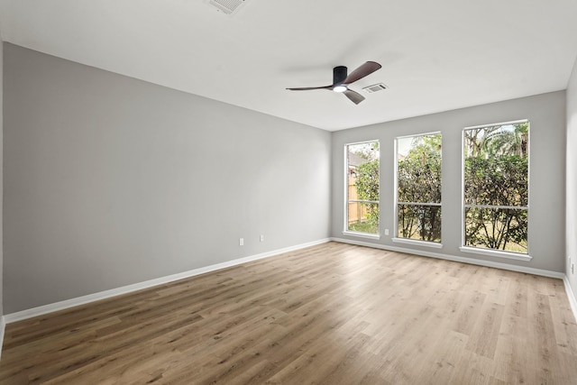 unfurnished room with ceiling fan and light wood-type flooring