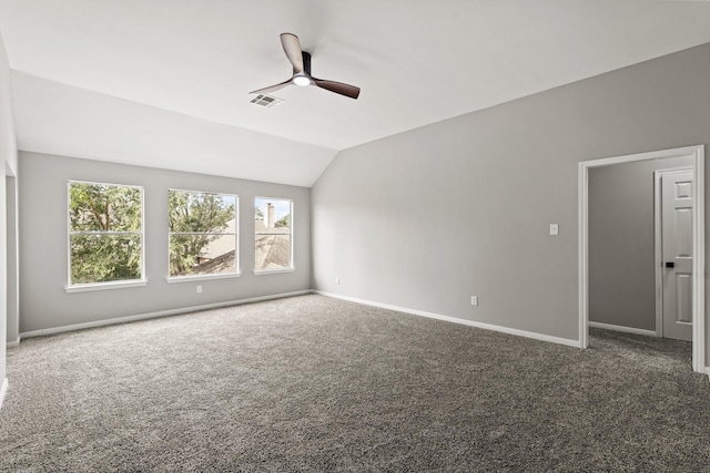 empty room with dark colored carpet, ceiling fan, and lofted ceiling