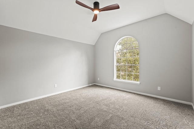 empty room featuring ceiling fan, carpet floors, and lofted ceiling