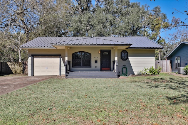 single story home featuring covered porch, cooling unit, a garage, and a front yard