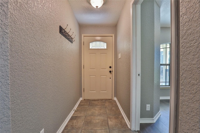 entryway featuring a healthy amount of sunlight and a textured ceiling