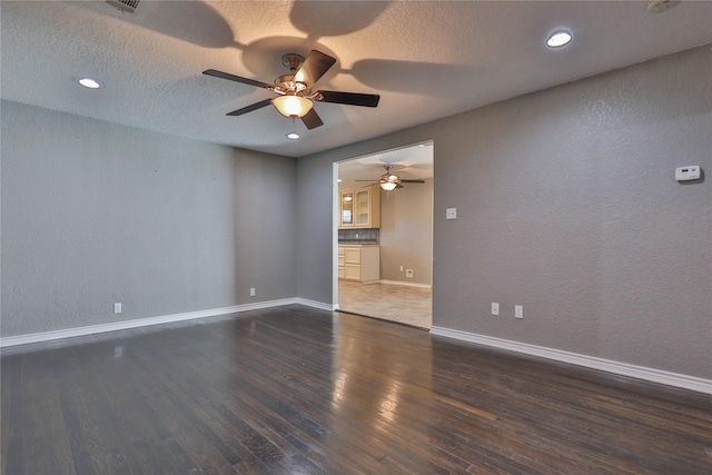 unfurnished room featuring ceiling fan and dark hardwood / wood-style flooring