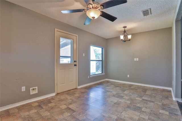 interior space featuring ceiling fan with notable chandelier