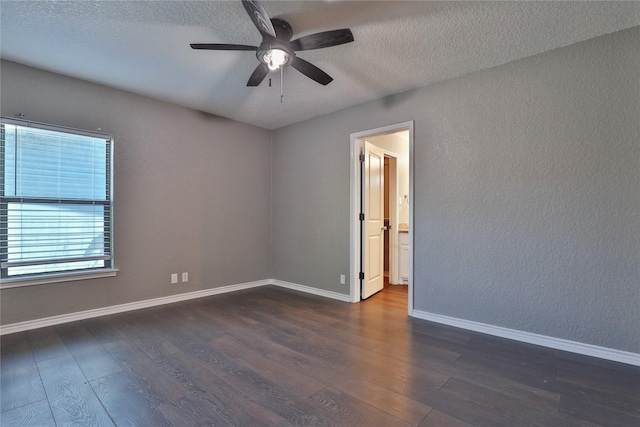 spare room with a textured ceiling, ceiling fan, and dark wood-type flooring