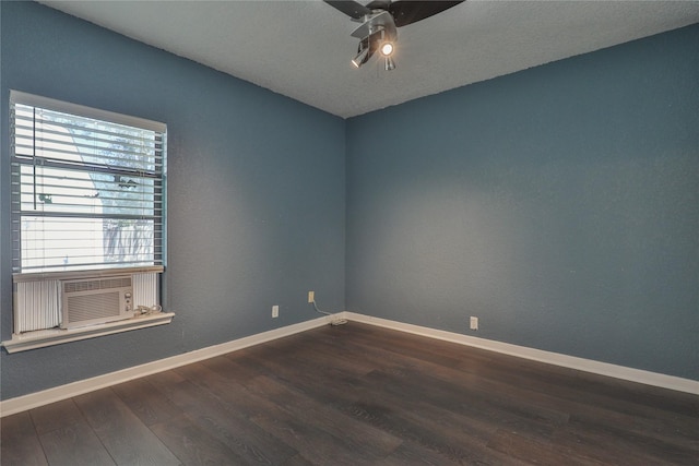 spare room featuring ceiling fan, cooling unit, and dark hardwood / wood-style floors