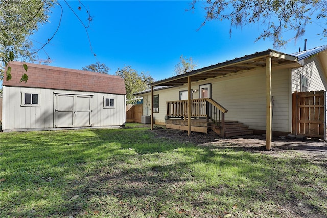 back of property with a storage shed and a yard