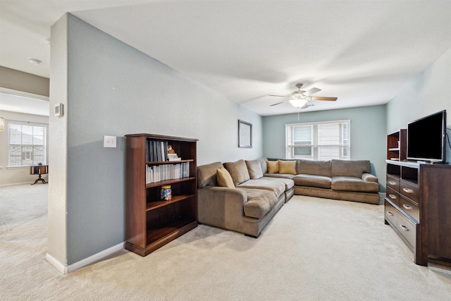 living room featuring light colored carpet and ceiling fan