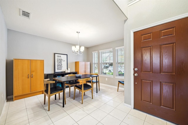 tiled dining area with a notable chandelier