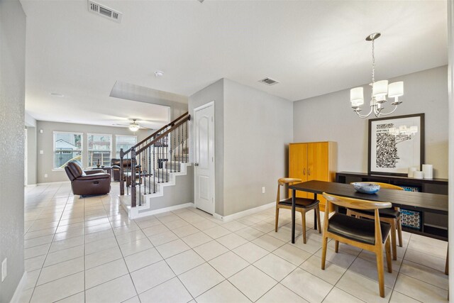 dining room with ceiling fan with notable chandelier and light tile patterned flooring