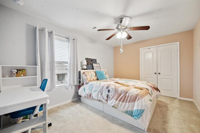 carpeted bedroom with a closet and ceiling fan