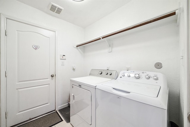 laundry area with washing machine and clothes dryer