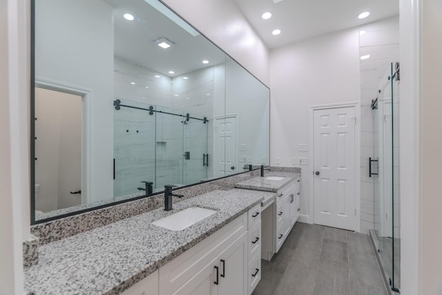 bathroom featuring vanity and an enclosed shower