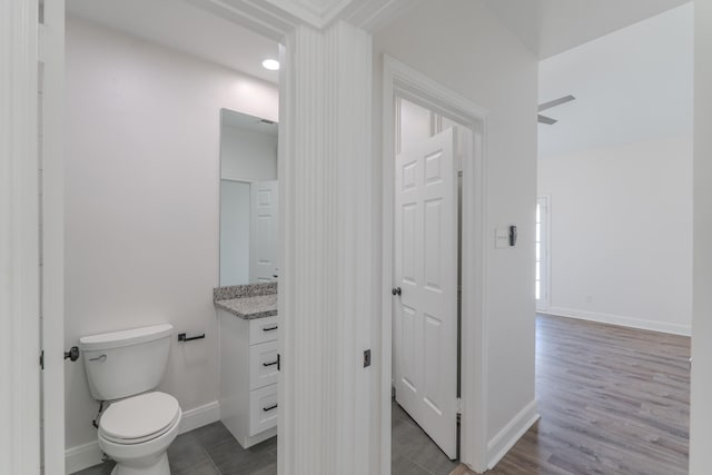 bathroom with ceiling fan, vanity, and toilet