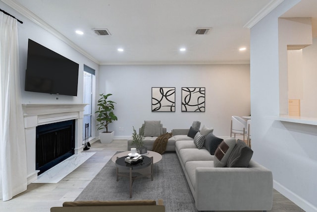 living room featuring light hardwood / wood-style floors and ornamental molding