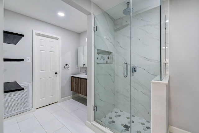 bathroom featuring tile patterned flooring, vanity, and an enclosed shower