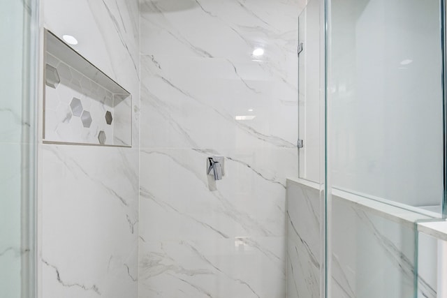 bathroom with a tile shower