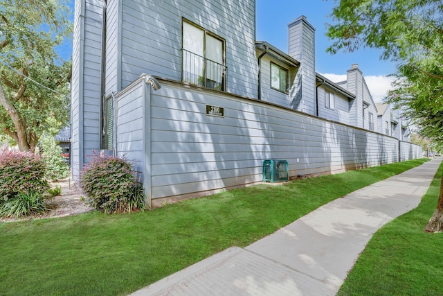 view of side of home featuring a lawn