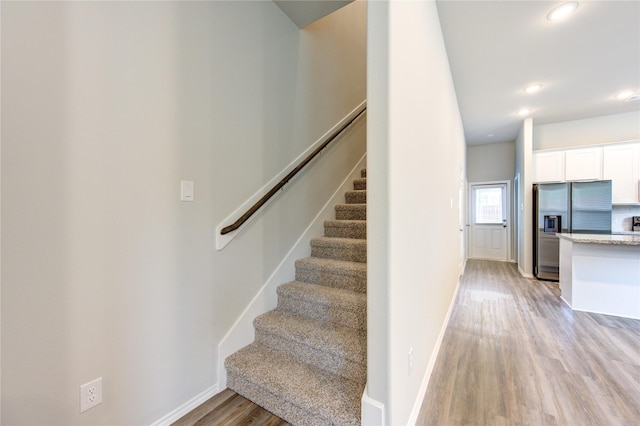 stairs with hardwood / wood-style flooring