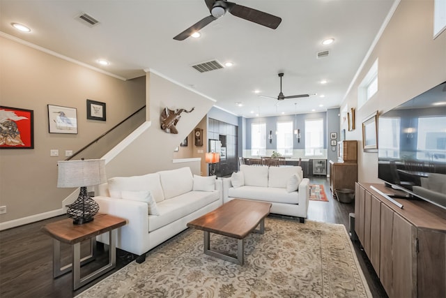 living room with crown molding and light hardwood / wood-style floors